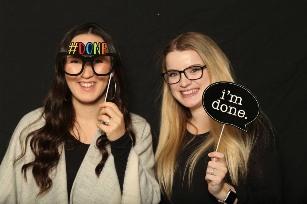 friends use props at gradfest photobooth
